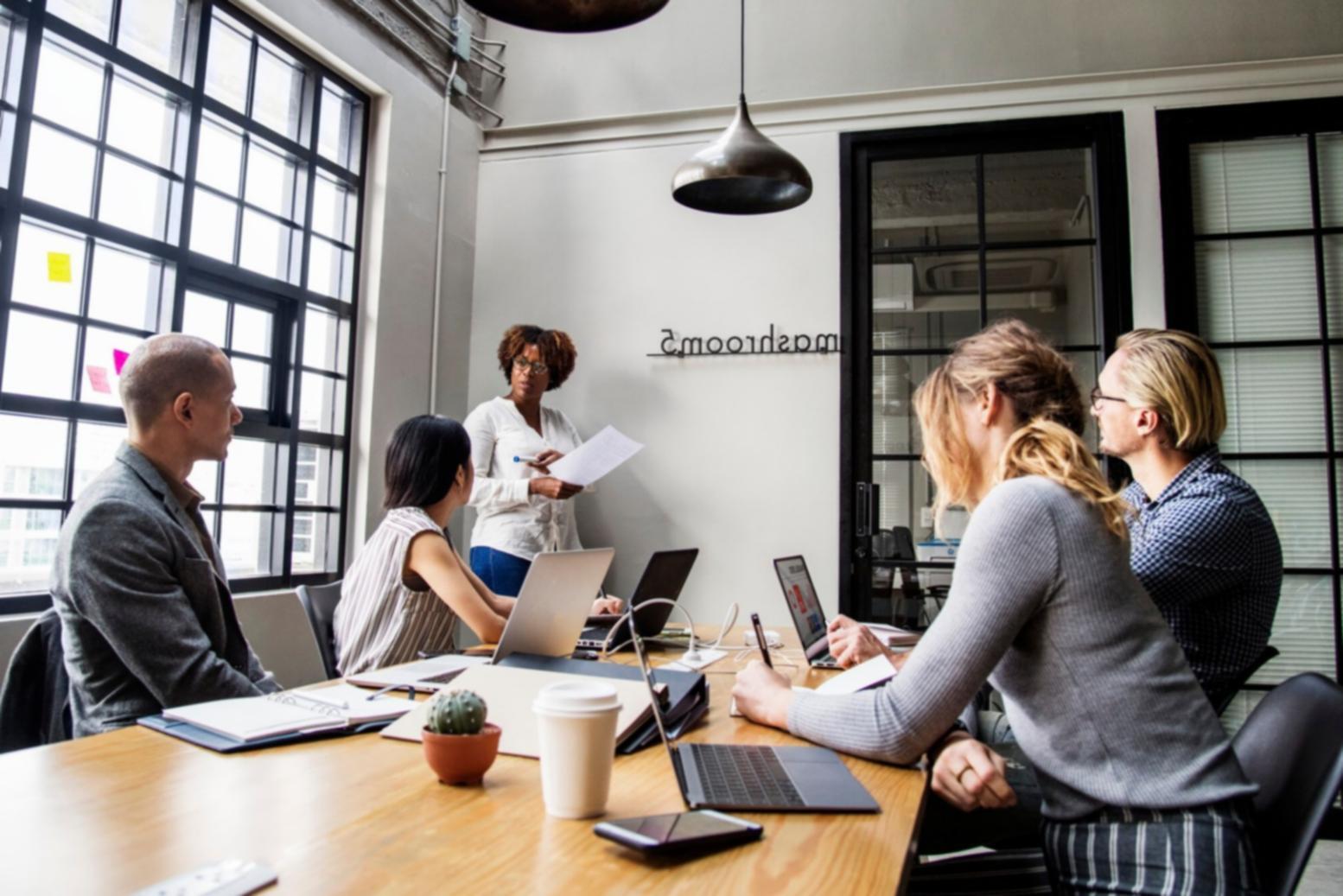 Business professionals reviewing financial reports during a consultation session